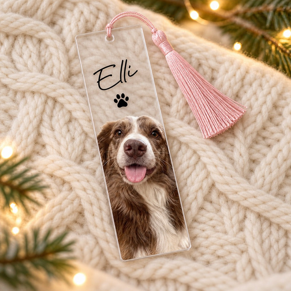 Personalized dog photo acrylic bookmark Elli lying on cozy knit fabric with holiday greenery
