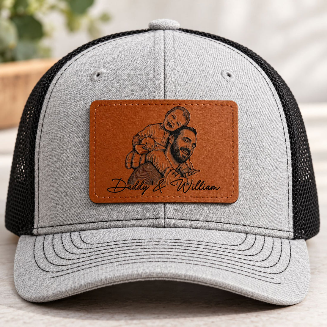 Macro closeup of engraved photo sketch leather patch on heather grey hat