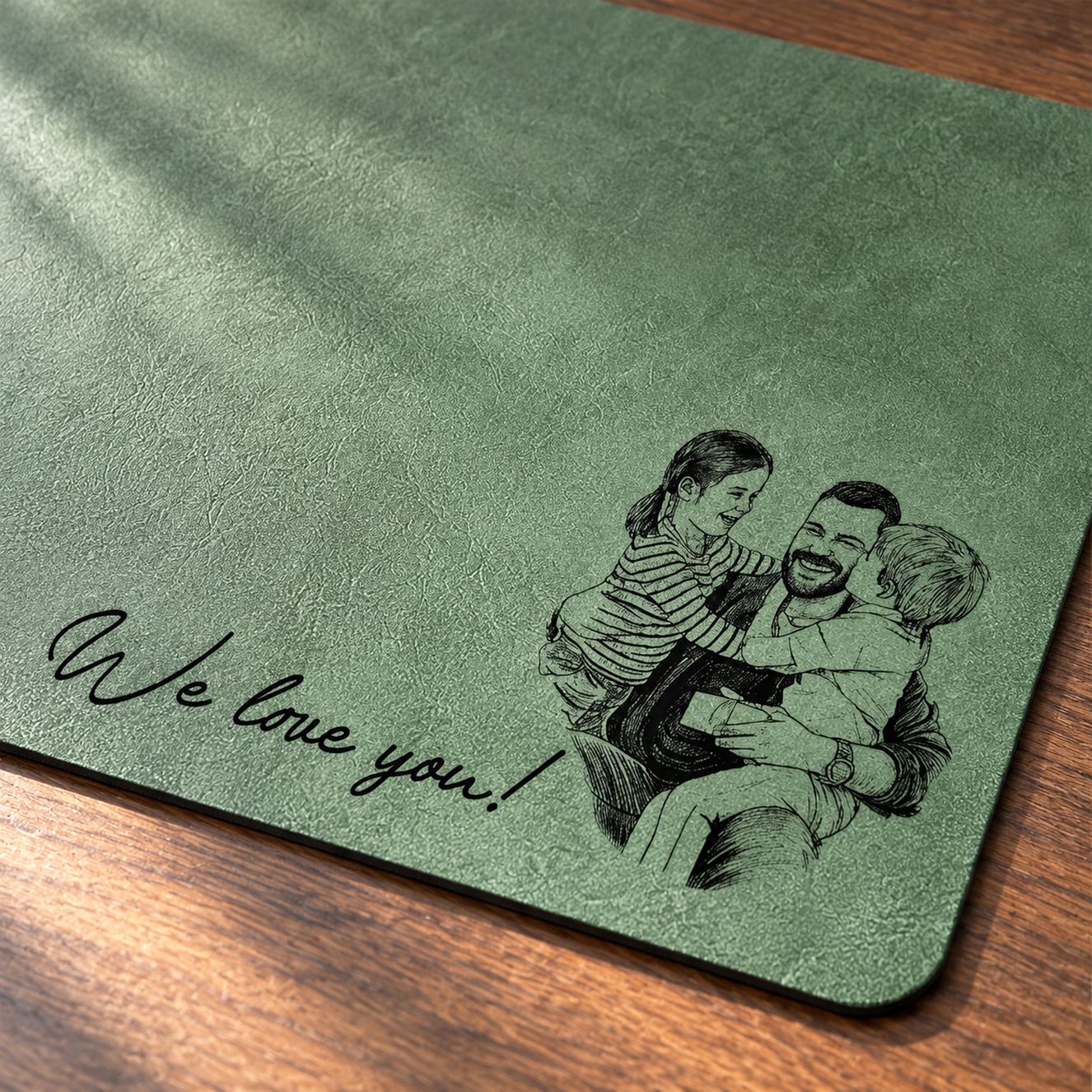 Close-up of custom sketch line art and We love you script on green desk mat