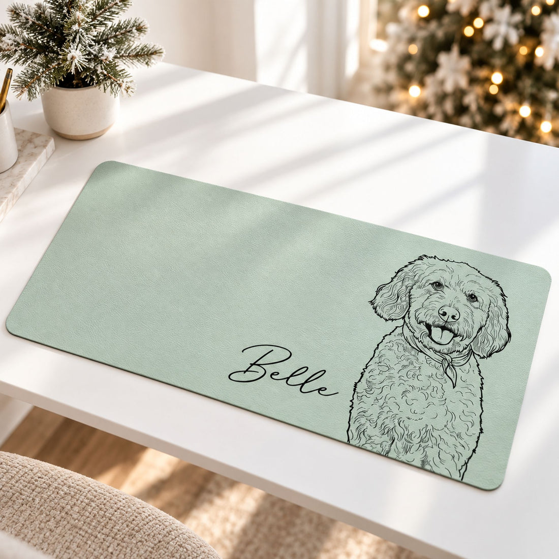 Custom pet portrait desk mat in sage green on a holiday desk with blurred Christmas tree lights