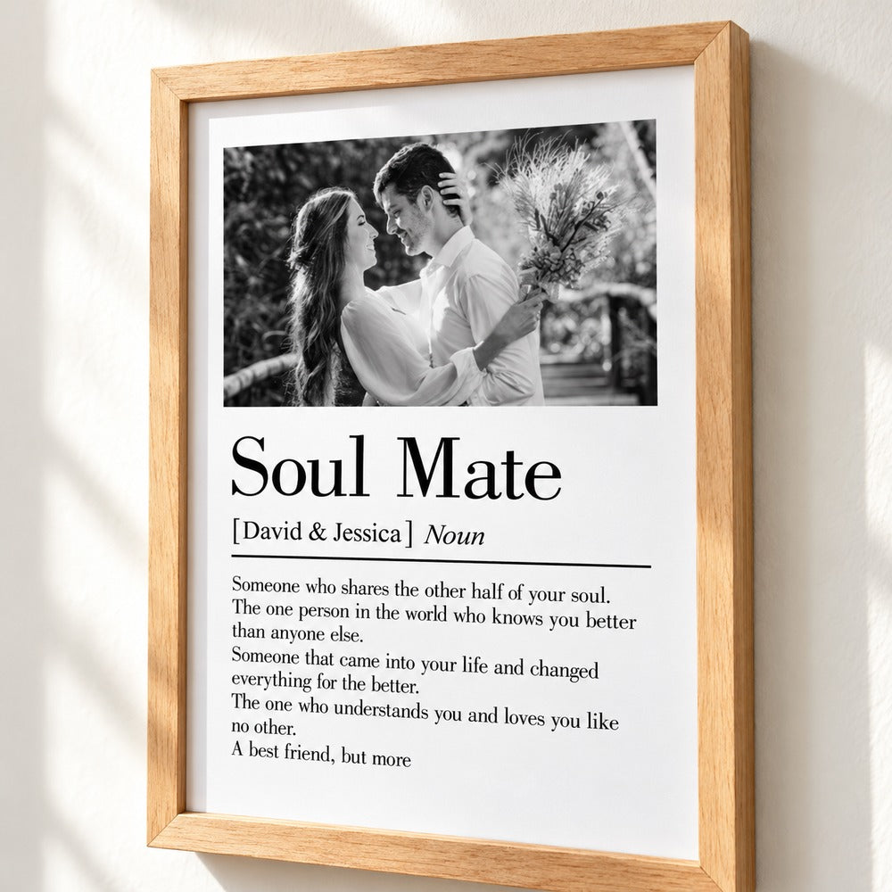 Close-up detail of matte paper print typography and natural wood frame corner on Soul Mate poster