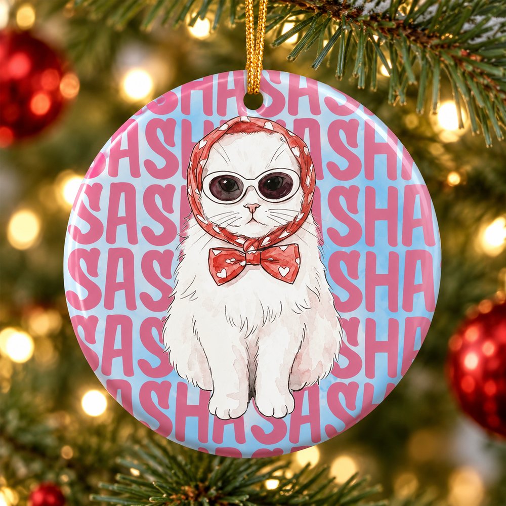 Personalized watercolor cat ceramic ornament hanging on a Christmas tree branch