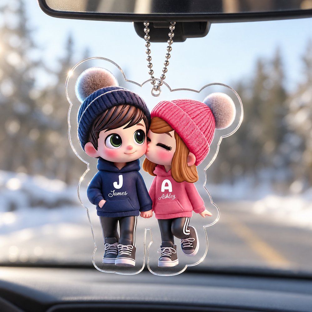Cute cartoon couple personalized acrylic car hanger hanging from a car rearview mirror in daylight