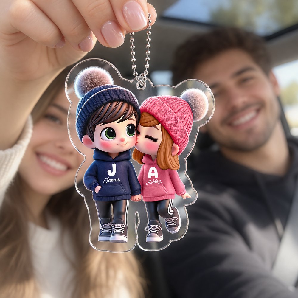 Happy couple in car holding their personalized cartoon couple walking acrylic car hanger