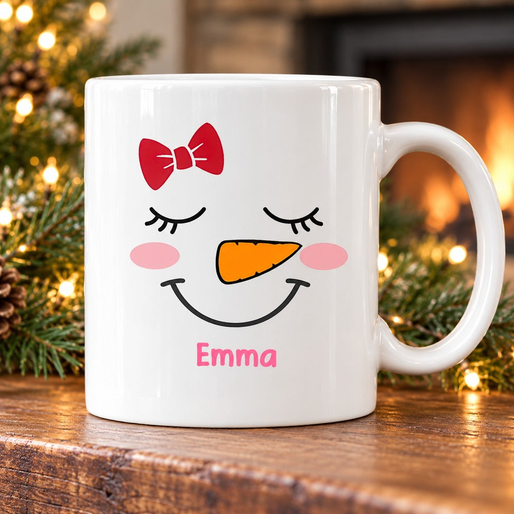 Cute Snowman Faces Christmas Mug Emma variant on holiday mantel with pine greenery