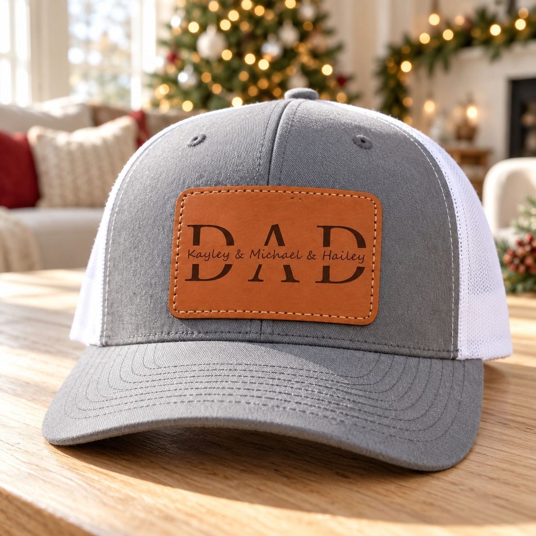 Custom Kids Name Dad Hat with leather patch on table near Christmas tree