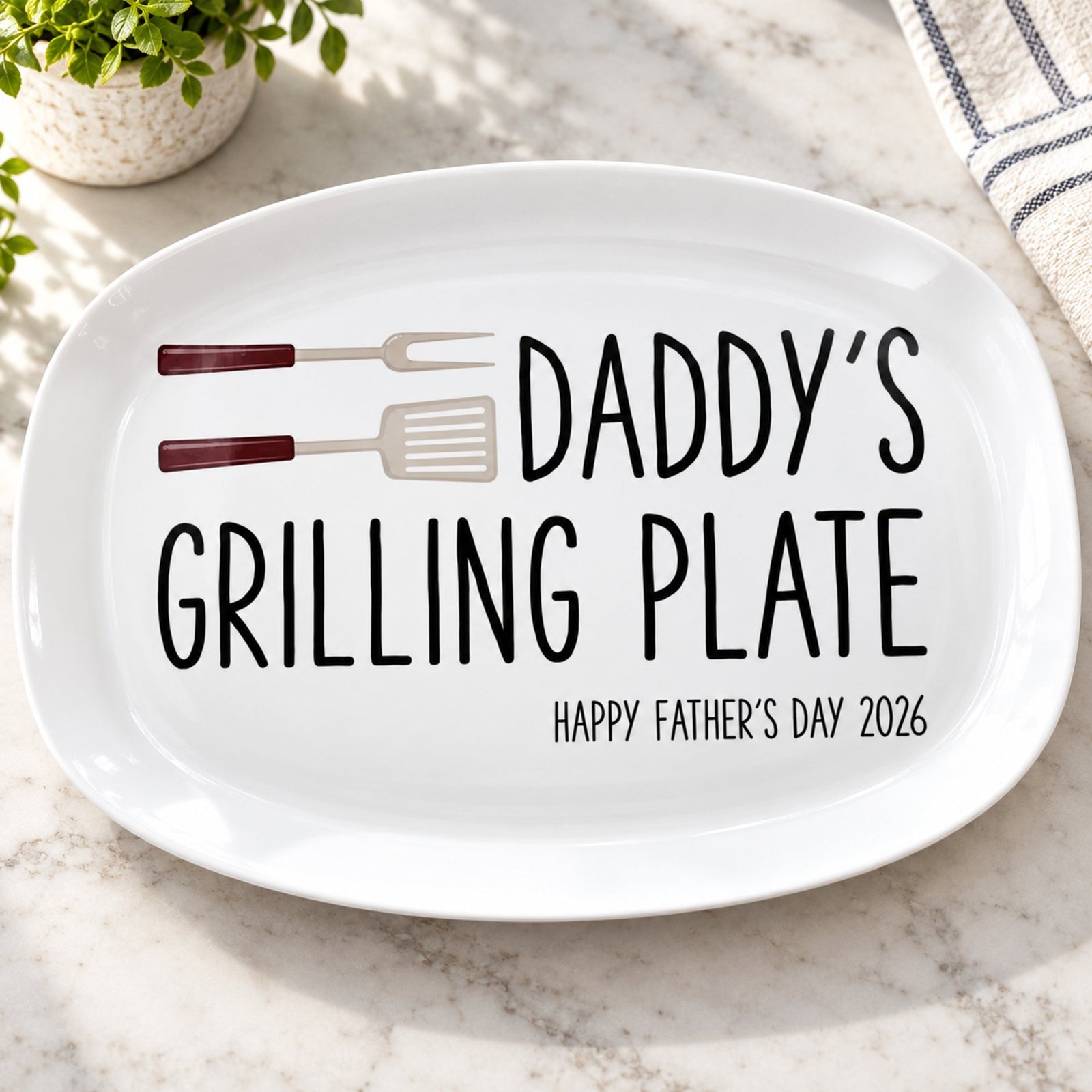 Close-up detail of the printed utensils and lettering on the personalized grilling platter