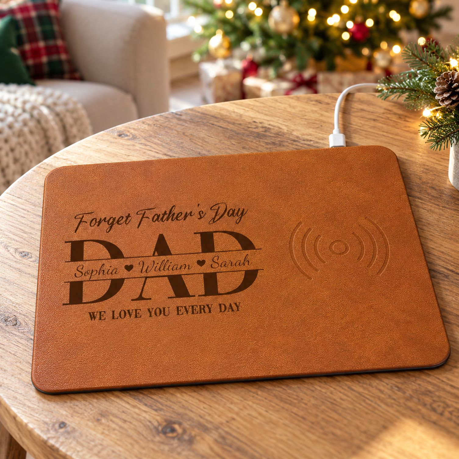 Personalized Dad charging pad on a wooden table with a Christmas tree in the background