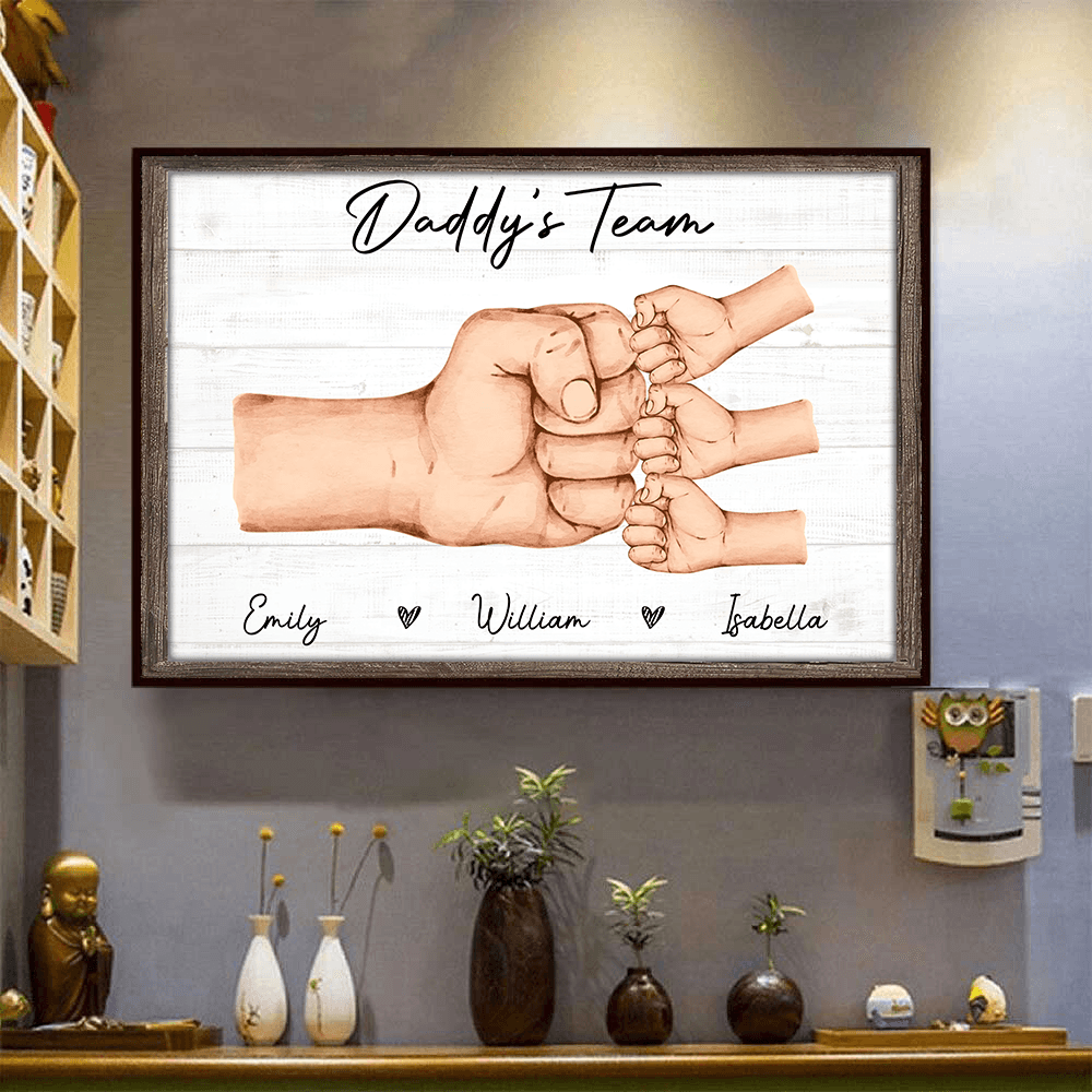 Personalized Daddy & Kids Fist Bump canvas print, a woman hanging the framed print on a wall