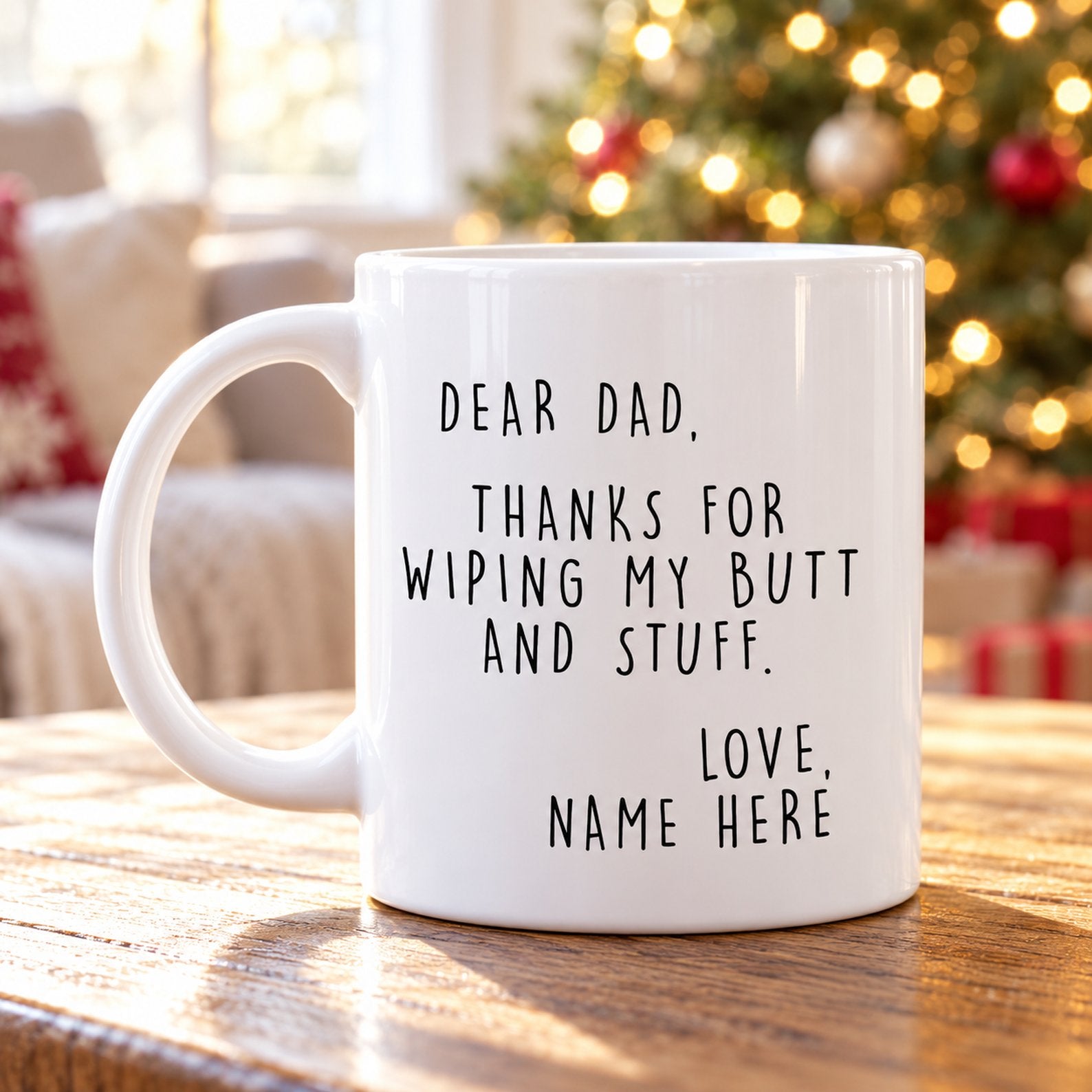 Personalized Dear Dad ceramic mug on a wooden table in front of a softly blurred Christmas tree
