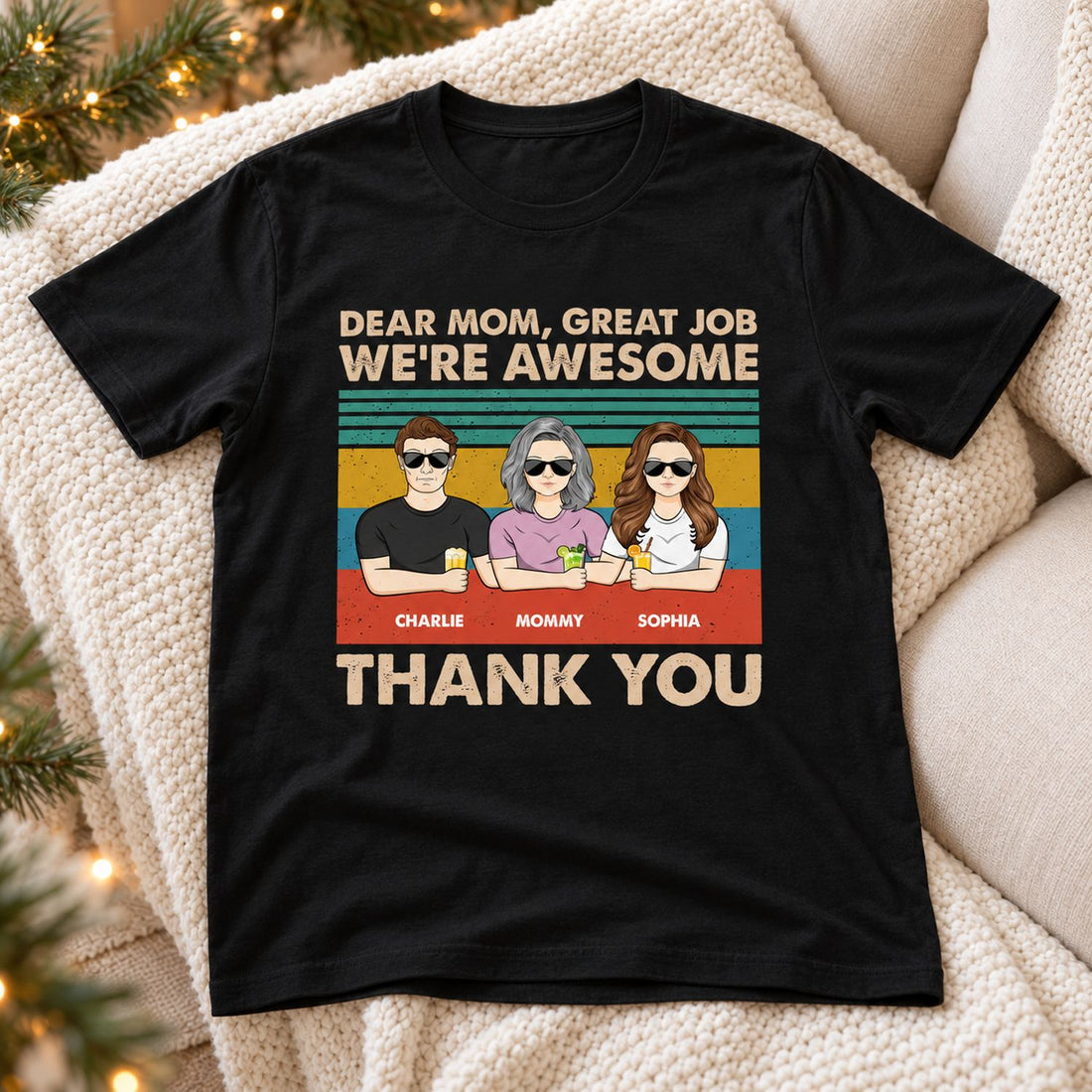 Personalized Dear Mom custom black t-shirt laid flat on cozy sofa with holiday greenery