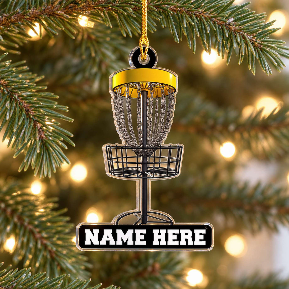 Personalized disc golf acrylic ornament hanging on a Christmas tree branch with warm lights