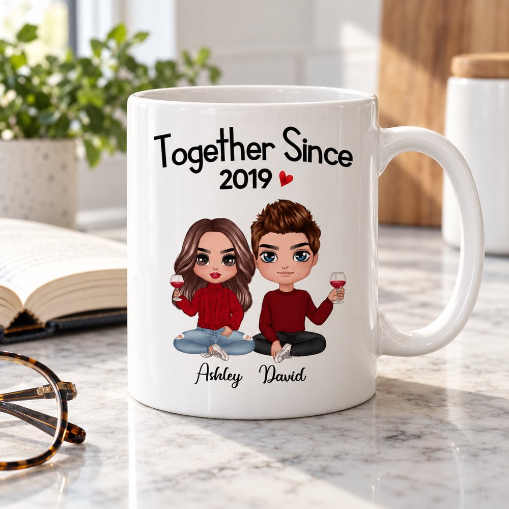 11oz personalized couple mug next to a book on a marble counter showing scale