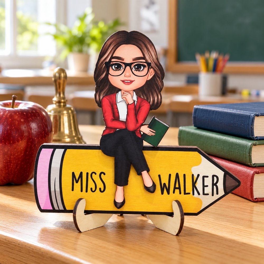 Personalized doll teacher sitting on pencil 2-layer wooden plaque displayed on a classroom desk