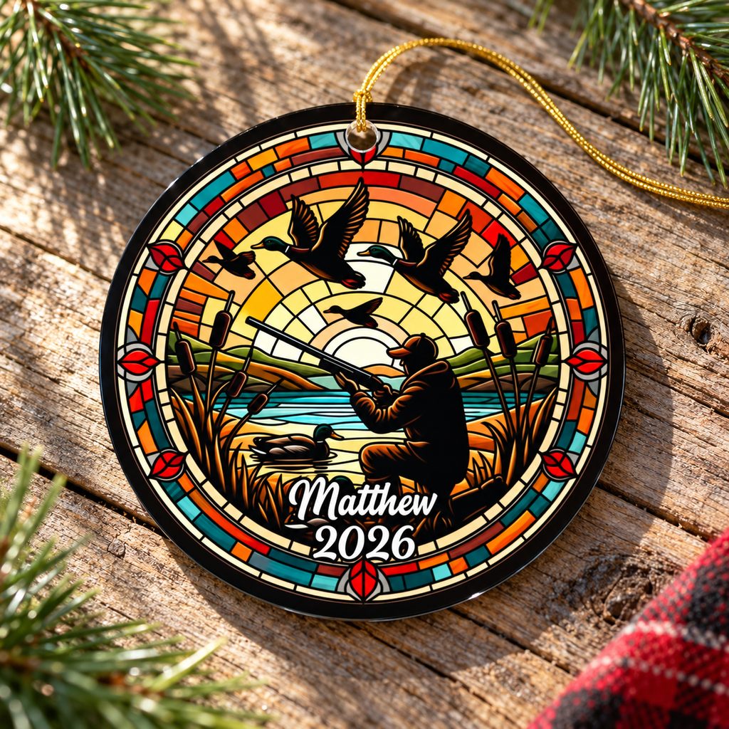 Duck hunting window suncatcher ornament lying flat on rustic wood with pine greenery