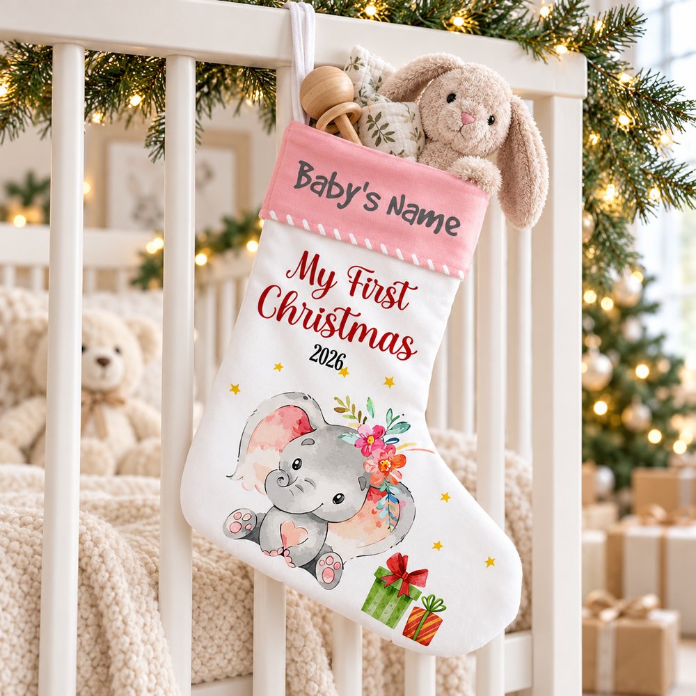 Personalized baby first Christmas elephant stocking stuffed with baby toys on a crib rail