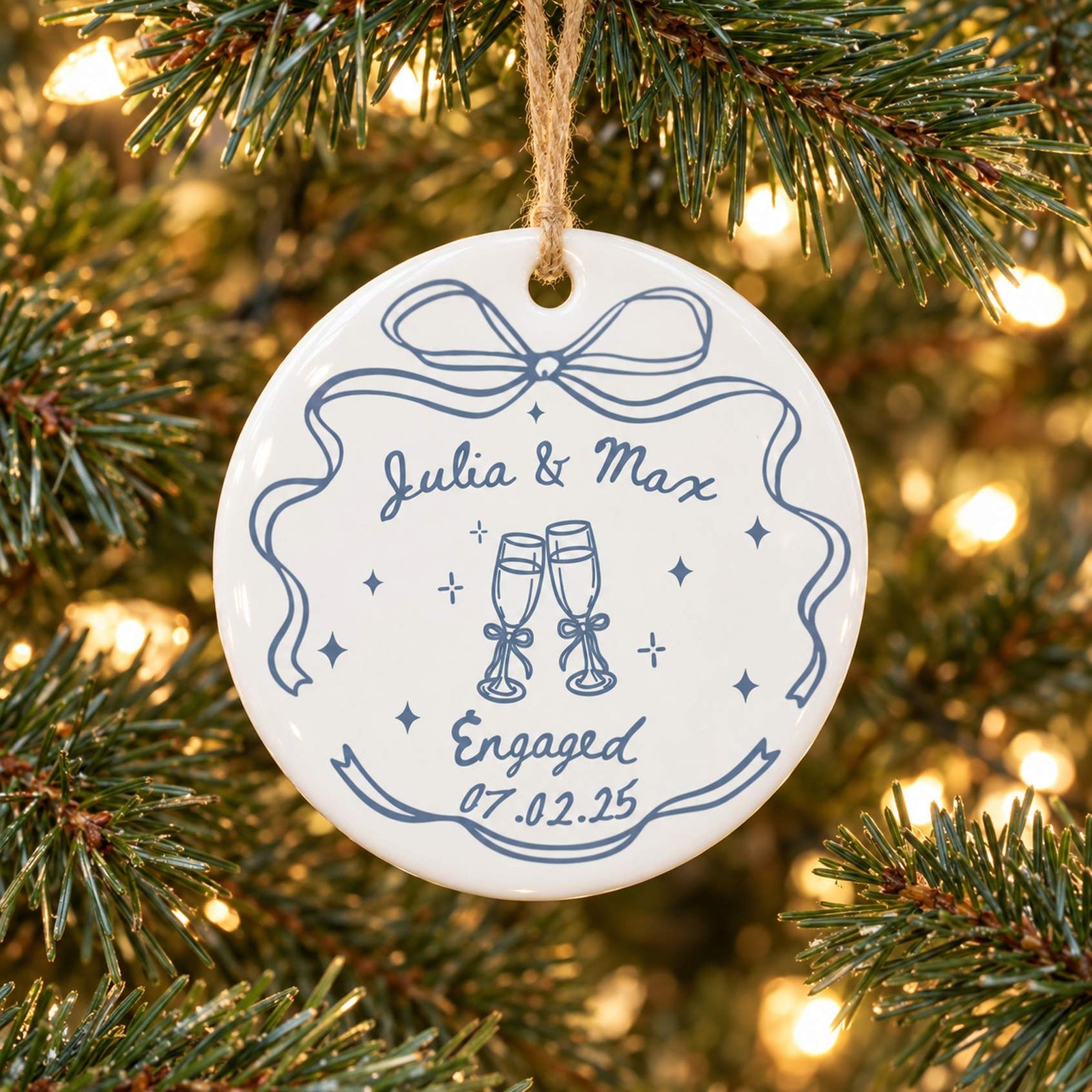 Personalized engagement ceramic ornament Julia and Max hanging on Christmas tree branch