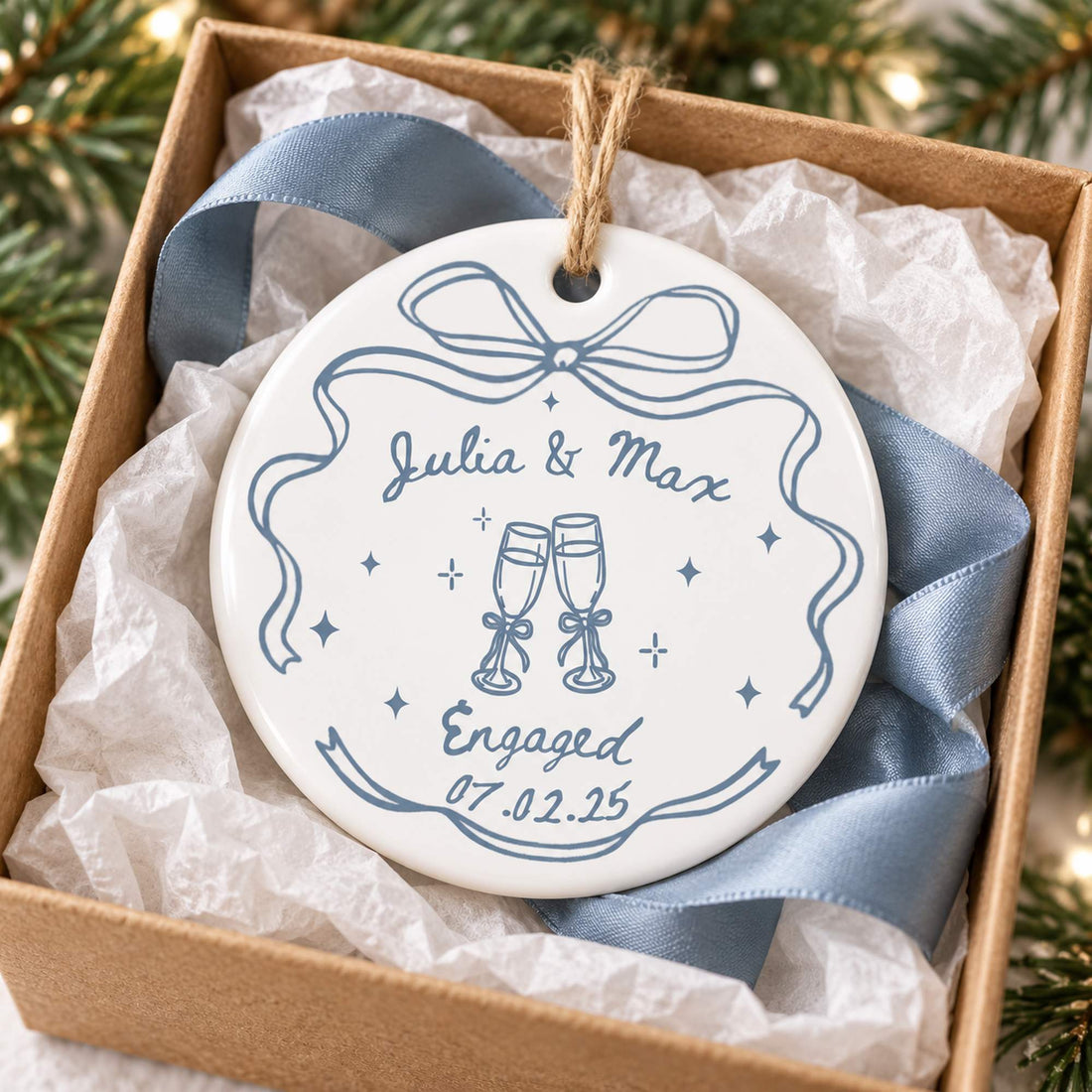 Personalized engagement ceramic ornament nestled in open gift box with tissue paper