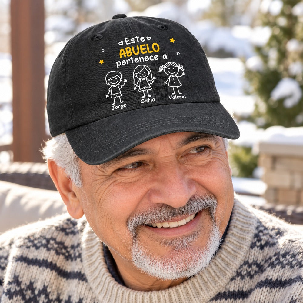 Grandpa wearing personalized Este Abuelo Pertenece A black washed denim cap outdoors