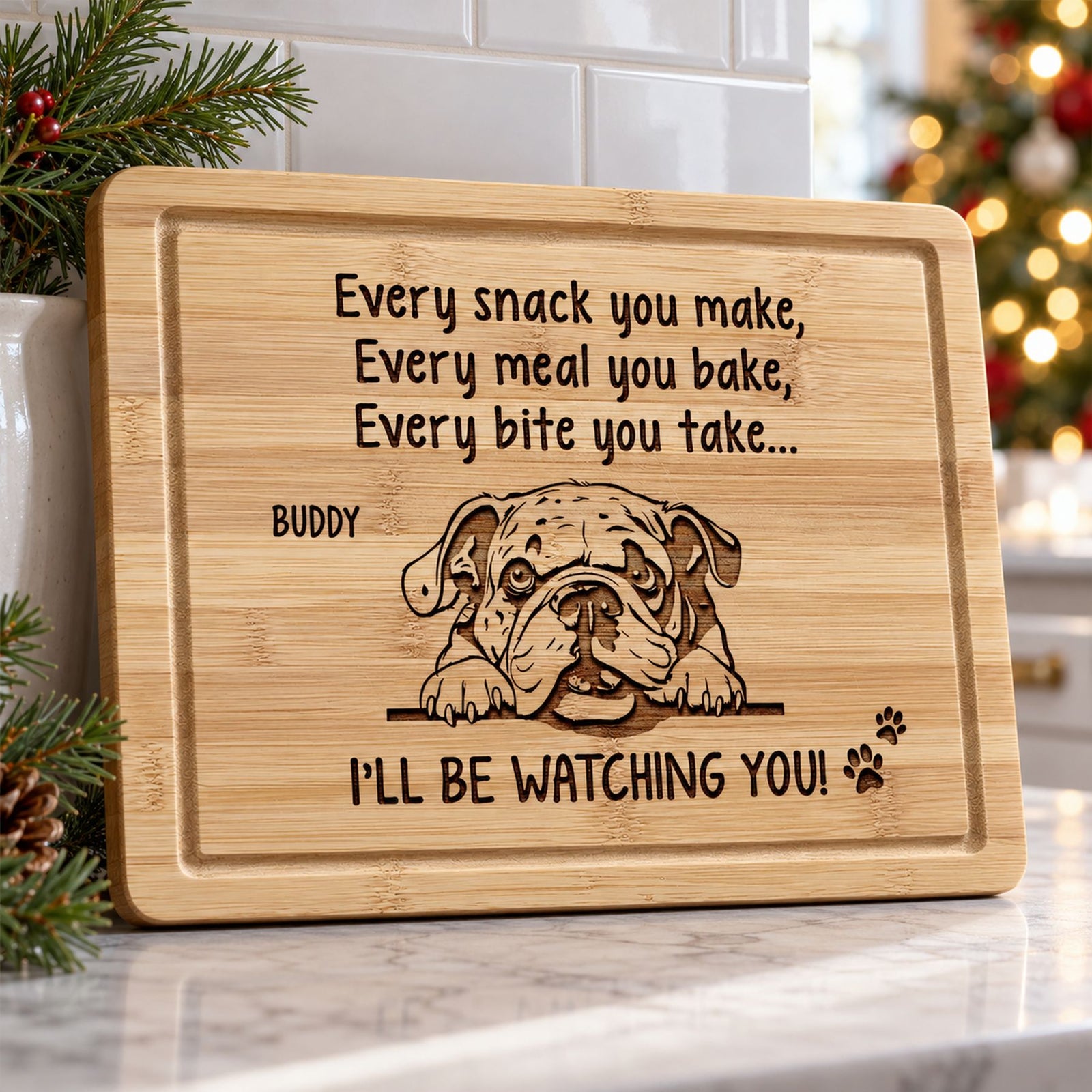 Personalized engraved dog cutting board leaning on a kitchen counter with Christmas decor