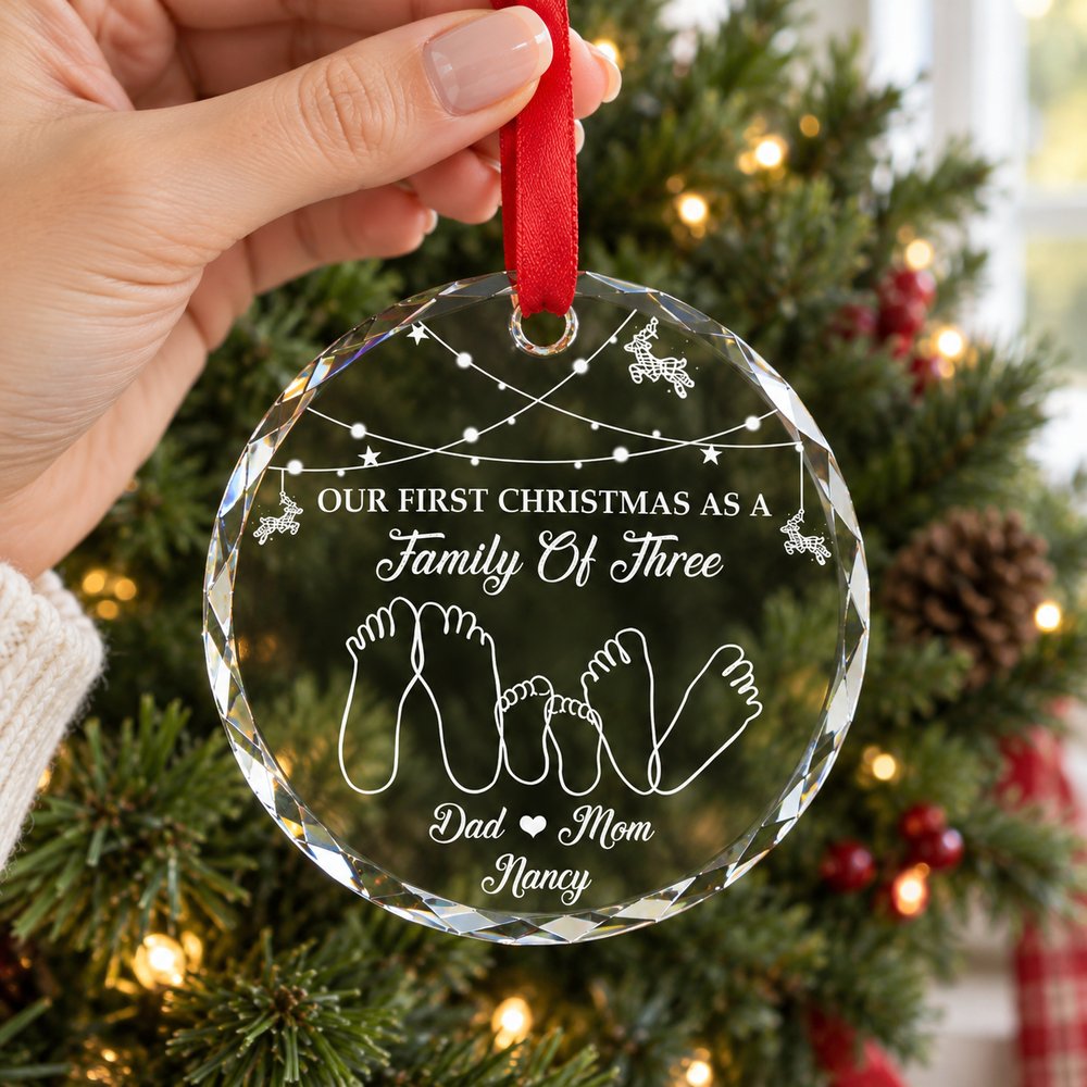 Hand holding 3 inch personalized family of three circle glass ornament for scale