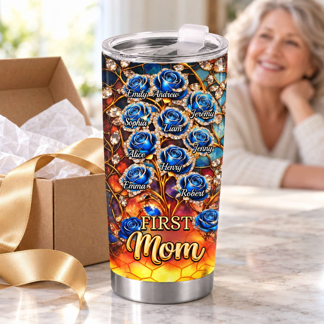 First Mom Now Grandma tumbler cup next to gift box and gold ribbon
