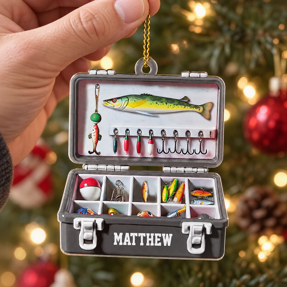 Hand holding 3.5 inch fishing tackle box acrylic ornament to show real size