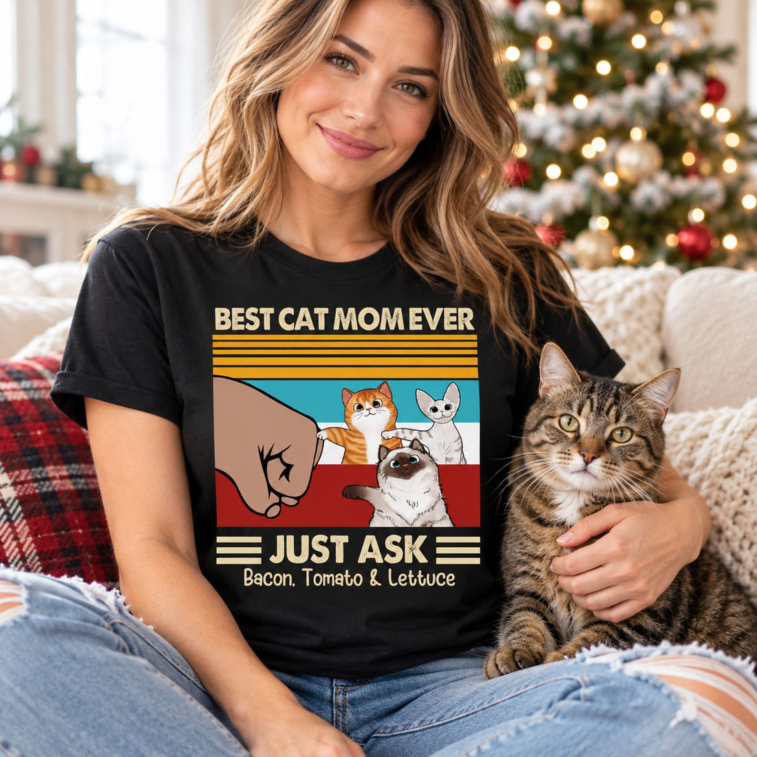Woman wearing Best Cat Mom Ever custom t-shirt holding her cat near a Christmas tree