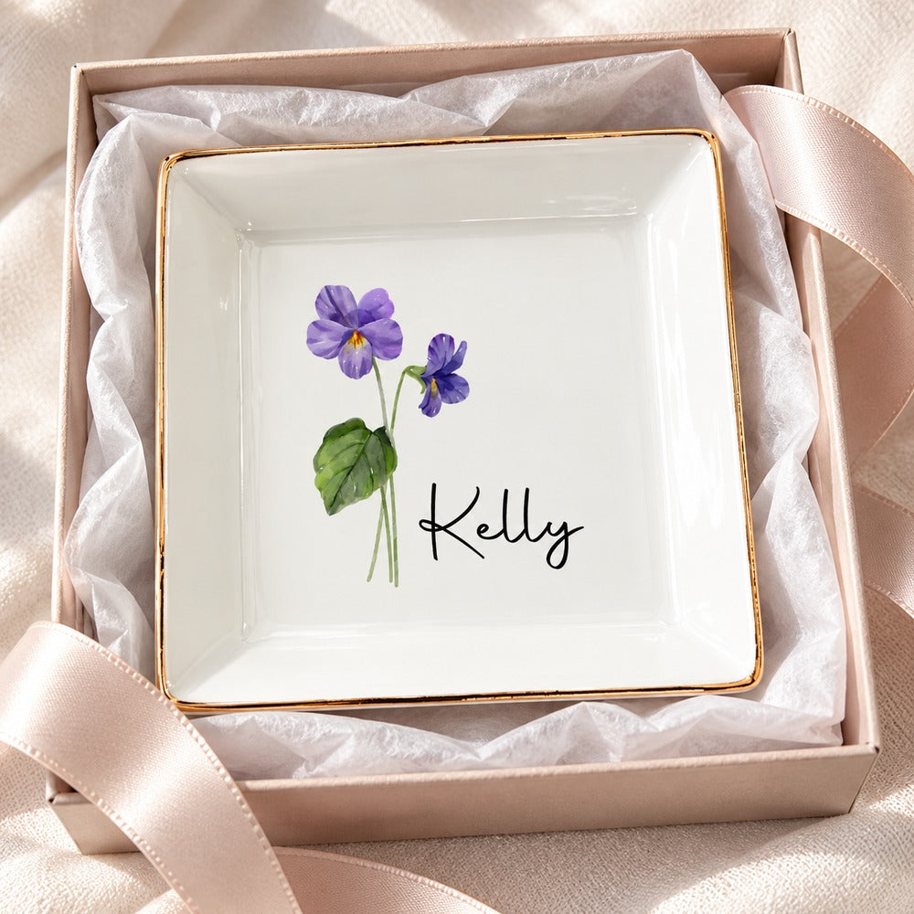 Personalized birth flower jewelry dish for Kelly nestled in an open gift box with tissue paper