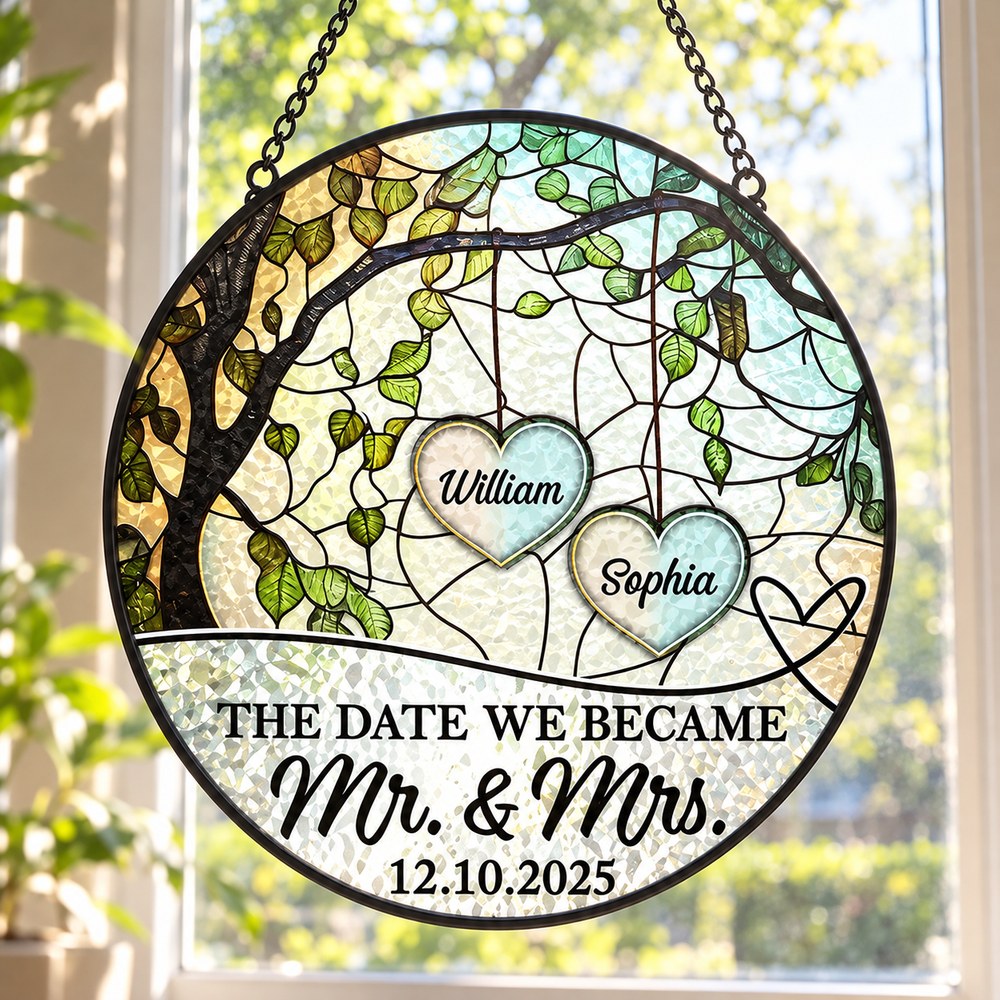 Personalized couple stained glass suncatcher hanging in a bright sunlit window
