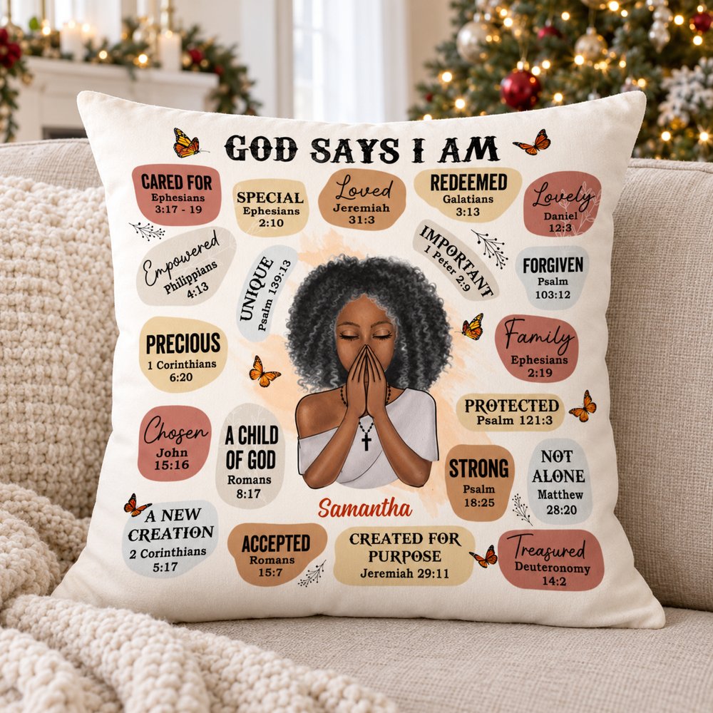 God Says I Am Bible Verse custom pillow on a cozy sofa with holiday tree in background
