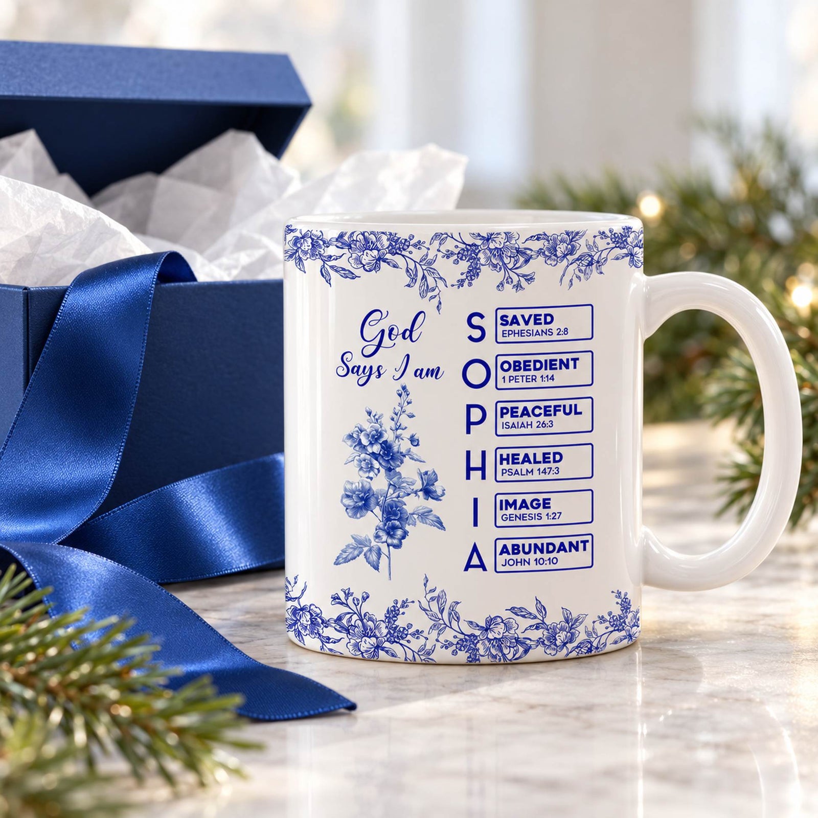 Personalized Christian birth flower mug next to a gift box with ribbon for Christmas