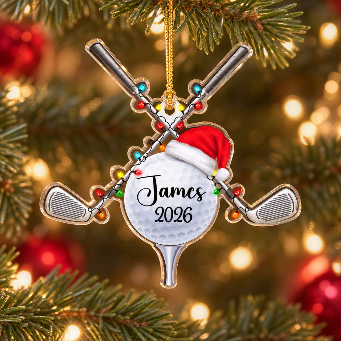 Personalized golf ball acrylic Christmas ornament James 2026 hanging on a festive pine tree branch