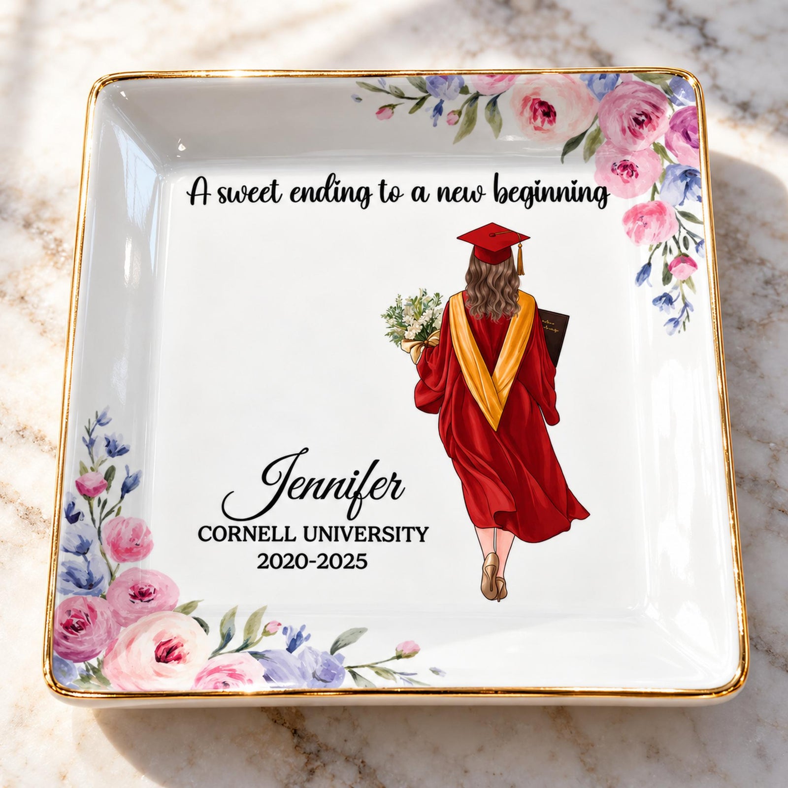 Close-up of glossy ceramic glaze, gold rim, and floral print on personalized graduation jewelry dish