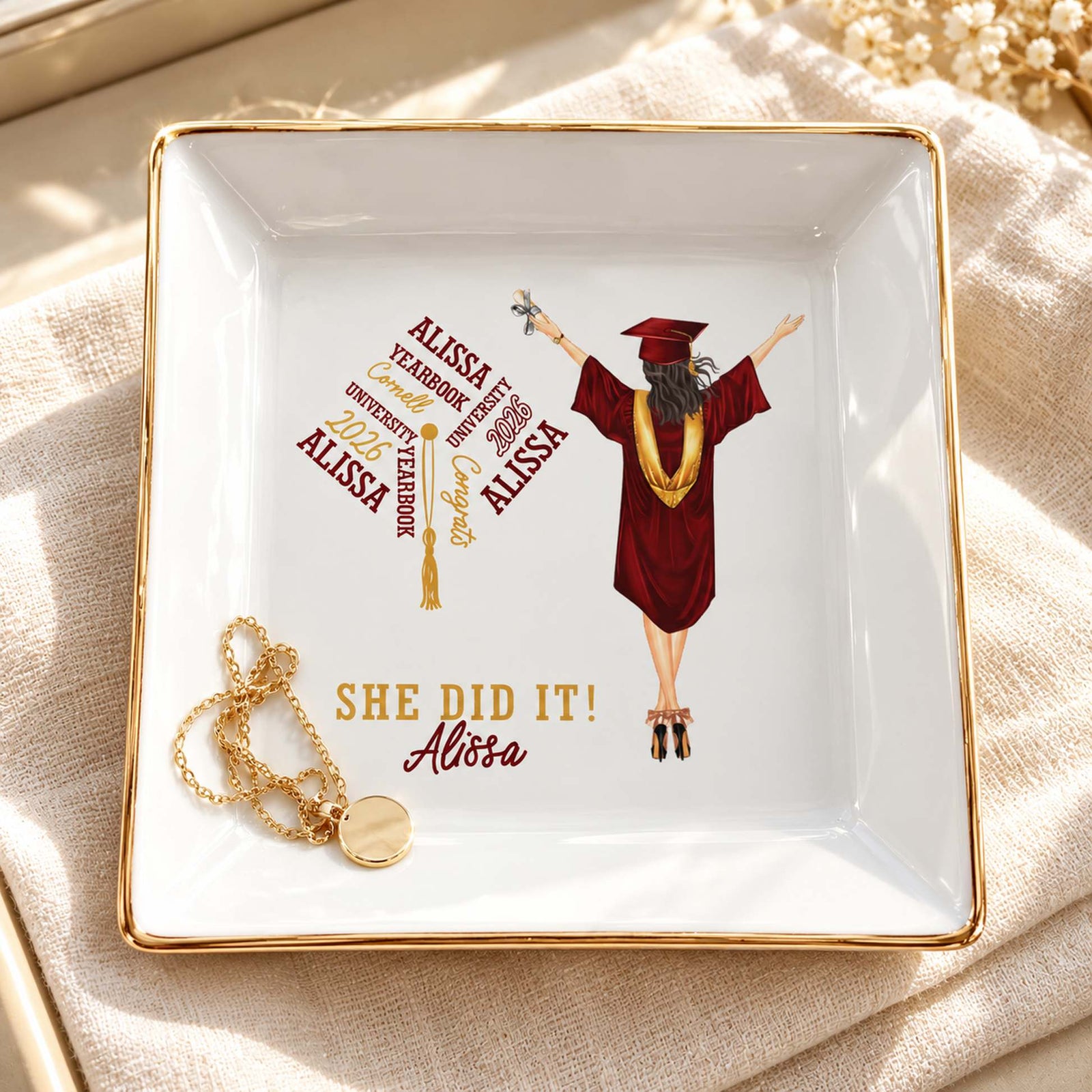 Personalized She Did It graduation jewelry dish holding a gold necklace on a vanity