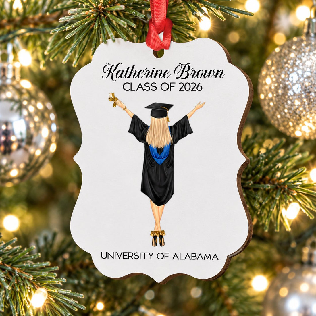 Personalized Class of 2026 wood graduation ornament hanging on a bright Christmas tree branch