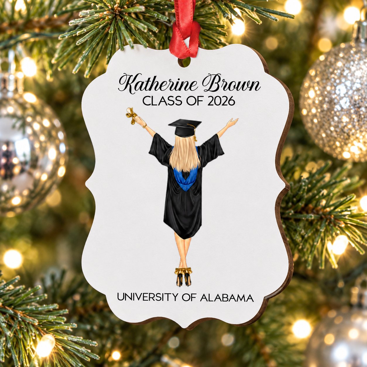 Personalized Class of 2026 wood graduation ornament hanging on a bright Christmas tree branch
