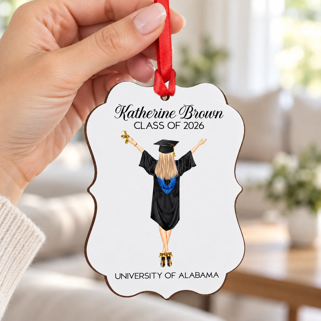 Hand holding the 4 inch personalized graduation wood ornament to show real size