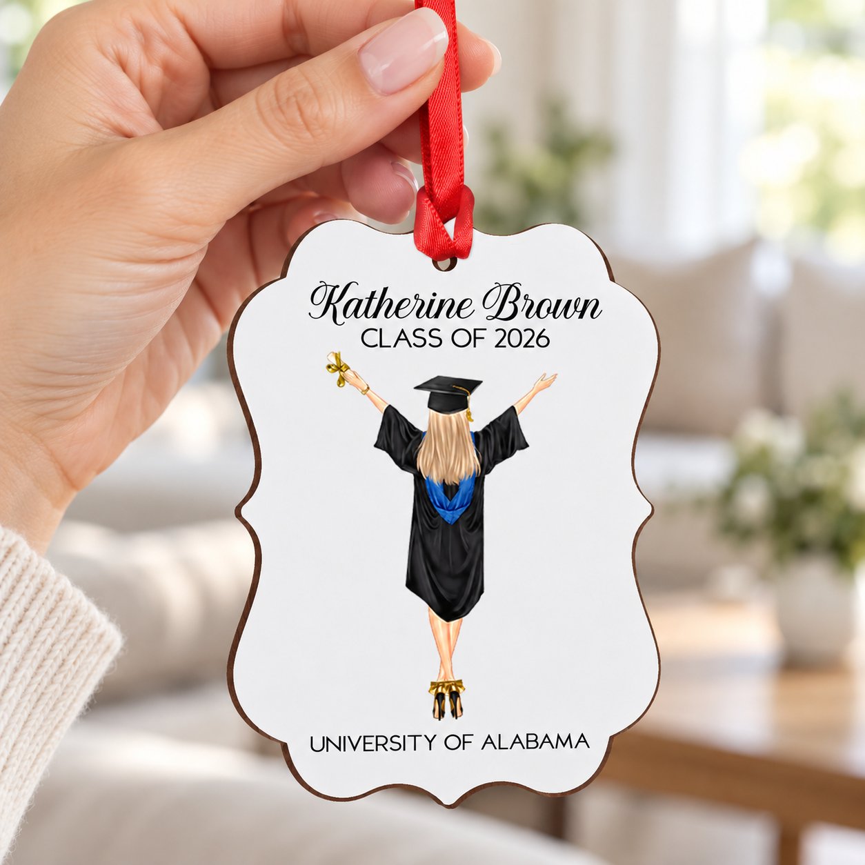 Hand holding the 4 inch personalized graduation wood ornament to show real size