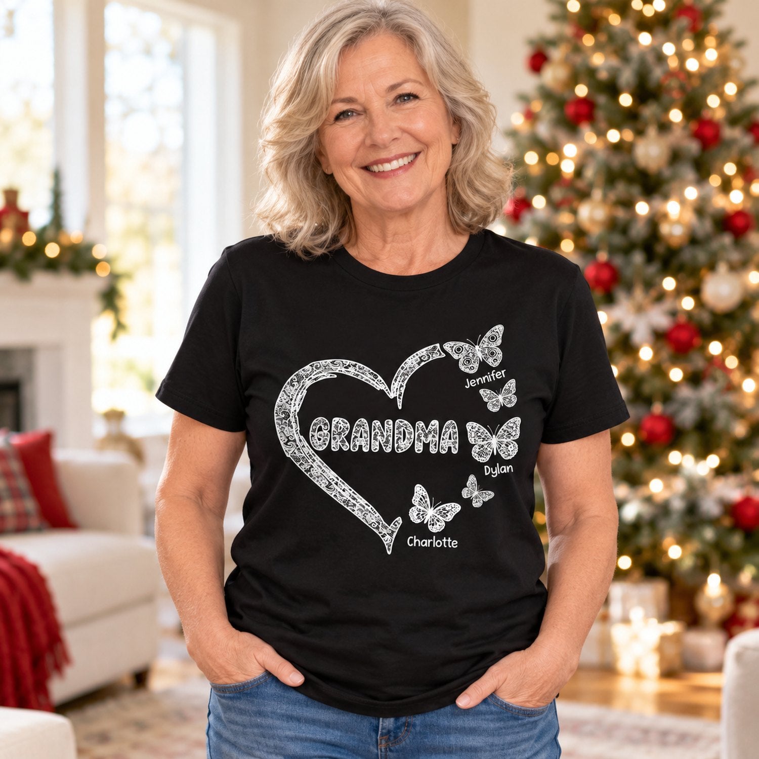 Grandma wearing personalized black lace butterfly heart t-shirt in a bright holiday living room