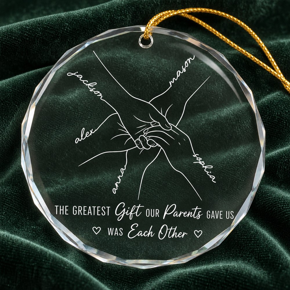Close-up of beveled edge clear glass sibling ornament showing white line art print