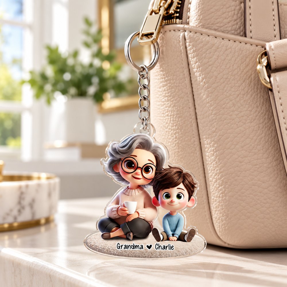 Personalized Grandma and Grandkid acrylic keychain hanging on a beige leather handbag zipper