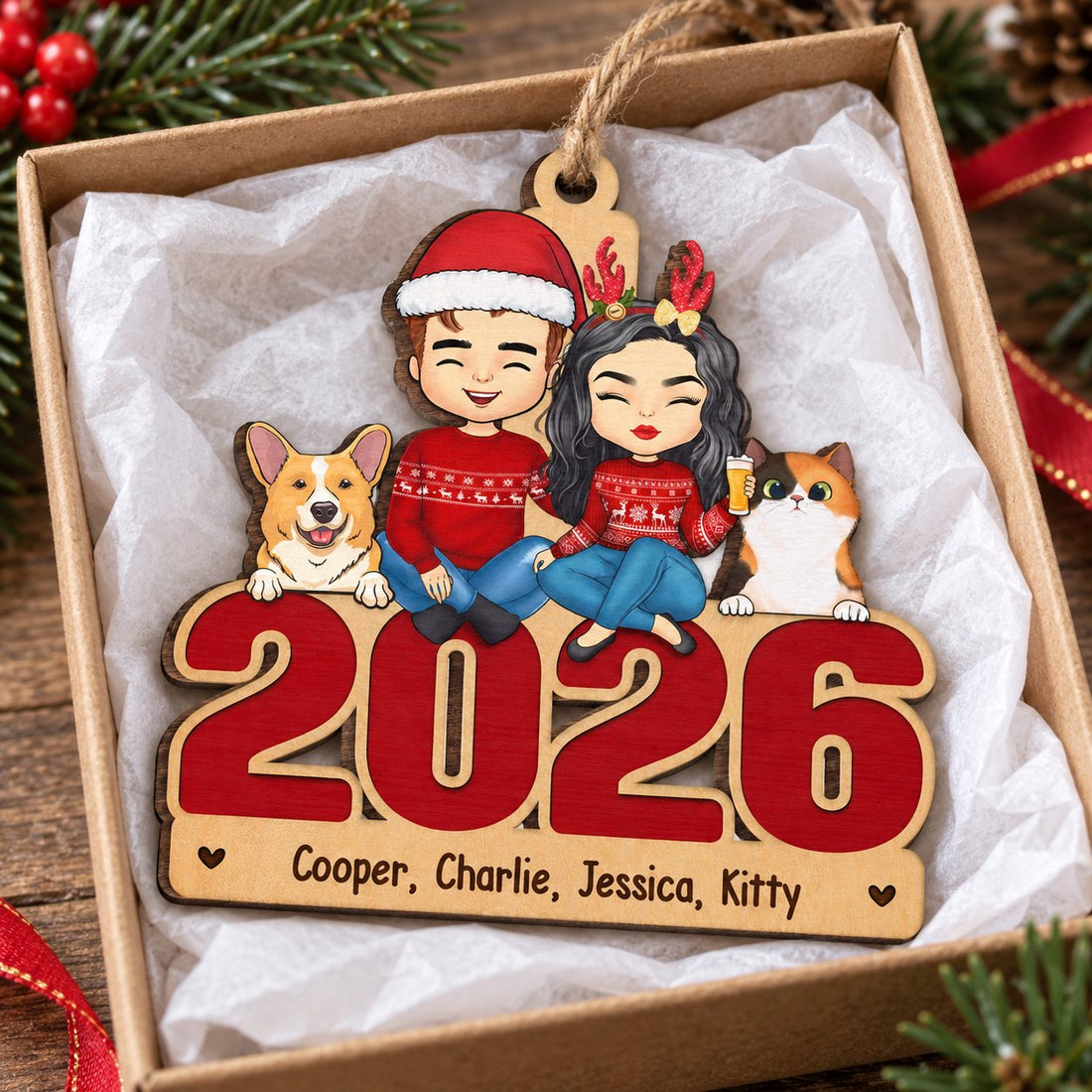 Personalized couple and pets Christmas ornament nestled in a small gift box with tissue paper