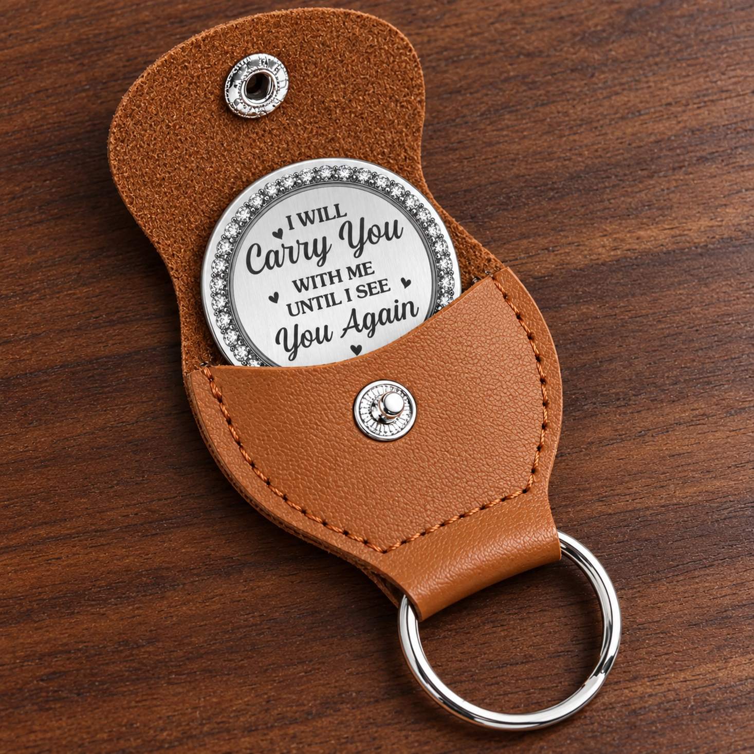 Macro closeup of stainless steel pocket hug coin engraving and stitched brown leather pouch