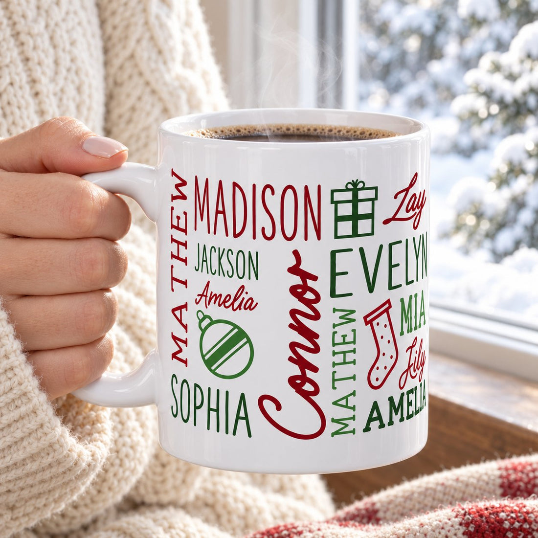 Personalized holiday repeating name ceramic mug held with steaming coffee in a bright winter window setting