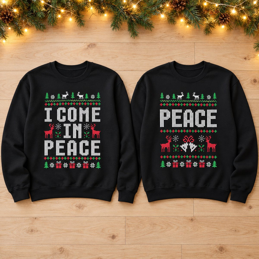 Matching I Come in Peace couple Christmas sweatshirts flat lay with holiday greenery