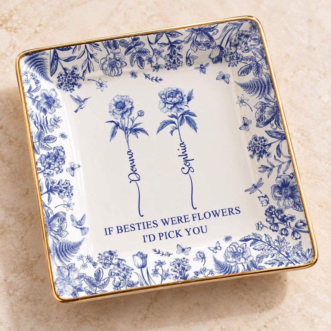 Close-up detail of blue floral print and gold rim on personalized best friends jewelry dish