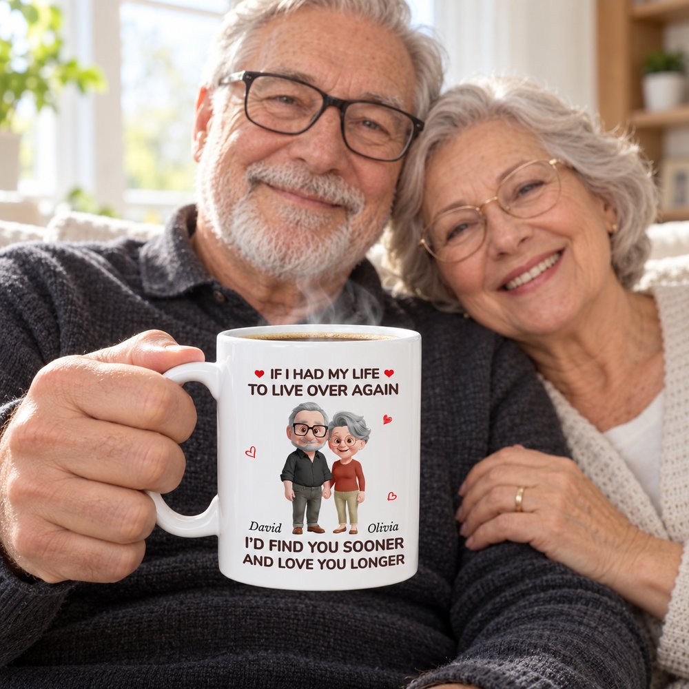 Personalized couple coffee mug held by older husband with wife on bright morning sofa