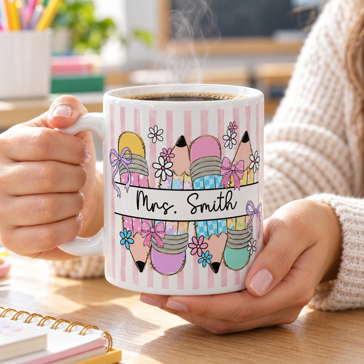 Personalized Mrs. Smith teacher ceramic mug held with warm coffee at a classroom desk