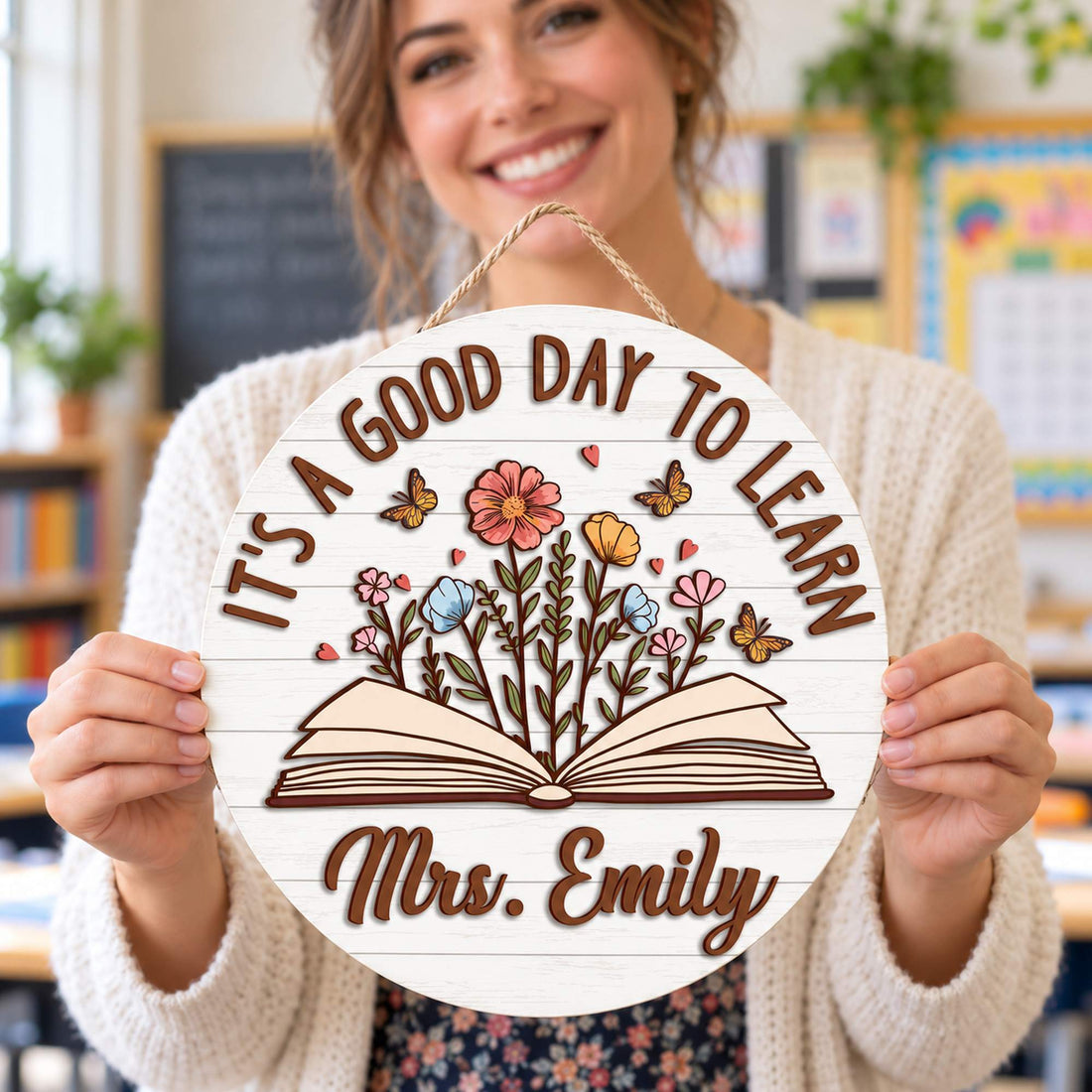 Female teacher holding her personalized It's A Good Day To Learn round wood sign
